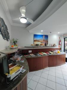 a kitchen with a counter with food on it at Gentil Hotel in Florianópolis