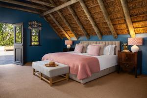 a bedroom with a large bed and blue walls at Grace House in Robertson +29 photos