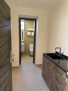 a bathroom with a sink and a toilet in a room at Midtown Lweibdeh Hostel in Amman +36 photos