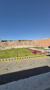 a parking lot with yellow and white lines in it at فندق حياة تاون حقل in Ḩaql +72 photos