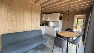 a living room with a couch and a table at Lodge T4 - Chalet proche de la mer in La Brée-les-Bains