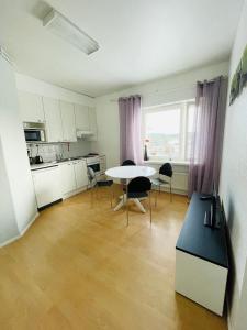a kitchen with a table and chairs in a room at Hotelli Aatto&Elli in Joutsa +14 photos