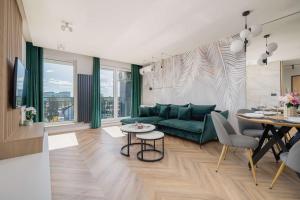 ティヒにあるAir Conditioned Apartment in Tychy with Parking and Desk by Noclegi Rentersの緑のソファとテーブルのあるリビングルーム +22枚の写真