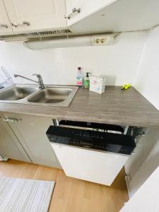 a kitchen with a sink and a counter top at Hotelli Aatto&Elli in Joutsa
