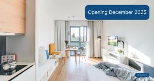 an open kitchen and living room with a table at smartments Bielefeld Hauptbahnhof in Bielefeld +15 photos