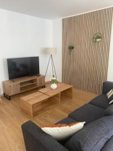 GussigniesにあるGîte du Marquisのソファとテレビのあるリビングルーム