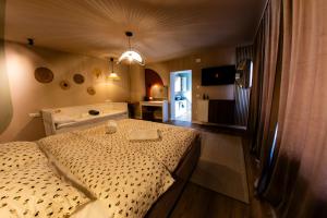 a bedroom with a large bed in a room at FLH - Citadel Garden - Casă cu Curte și Parcare Privată lângă Cetatea Alba Carolina - Loc de Joacă și Ciubăr in Alba Iulia