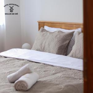 a bed with two towels laying on top of it at Hotel & Restaurant Mulliri me Erë in Rahovec