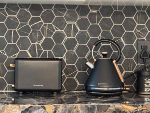 a black tea kettle sitting on a kitchen counter at Urban Oasis Penthouse-Jacuzzi! in Cape Town