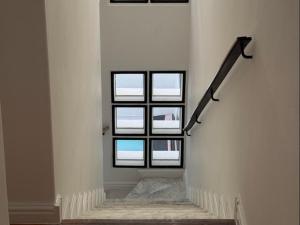 a stairway with four windows in a building at Urban Oasis Penthouse-Jacuzzi! in Cape Town