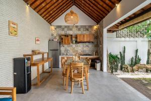 a kitchen and dining room with a table and chairs at Renovated 3BR Villa in Prime Bingin Location in Uluwatu