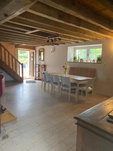 a kitchen and dining room with a table and chairs at Le Moulin de la Doltière in Châteauvieux