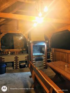 a dining room with a table and a stove at Casuta din LAZ in Onceşti +14 photos