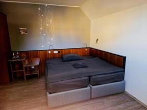 a bedroom with a bed in a room with a table at Hotel Sonnenschein in Bad Liebenwerda