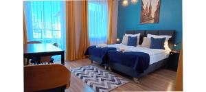 a bedroom with two beds and a desk and a piano at Sleep In Apartament Centrum in Wrocław