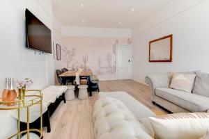 a living room with a couch and a table at Seafront apartment in Bognor Regis