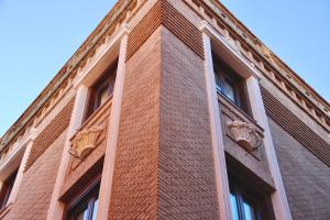 a brick building with two windows on the side of it at San Ginés Rooms Self Check-In in Toledo