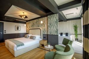 a hotel room with a bed and a chair at The Fourth Dimension by Domidea in Rome