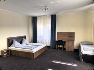 a hotel room with a bed and a desk at Art Hotel in Augsburg