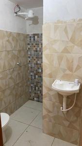 a bathroom with a sink and a toilet at Hospedaria Dona Alice in Lençóis