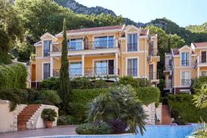 a villa with a swimming pool in a resort at Boka Kotorska Apartmani in Gornji Orahovac