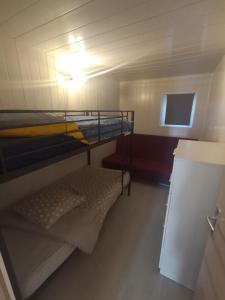 a small room with a bunk bed and a refrigerator at Villa Bel Air in Saint-Étienne-les-Orgues +20 photos