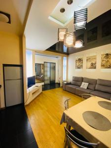 a living room with a couch and a table at Real Home Apartments in Kiev Center in Kyiv