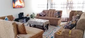 a living room with two couches and a table at SEBULENI SEA LUXURY HOMESTAY WALK TO NYALI BEACH Mombasa in Mombasa
