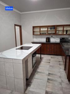 cocina con encimera blanca y armarios de madera en Good Morning Retreat, en Springs