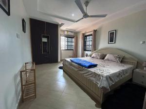 a bedroom with a bed and a ceiling fan at Modern and Unique 2 Bedroom Home in Accra