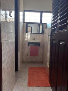 a bathroom with a sink and a red towel at Modern and Unique 2 Bedroom Home in Accra +17 photos