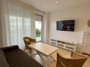 a living room with a couch and a table at Amenábar Ocean Suites by Staycare in Costa Ballena