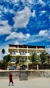 a person walking in front of a building at Tangawizi Lodge Zanzibar - Adults Only in Jambiani