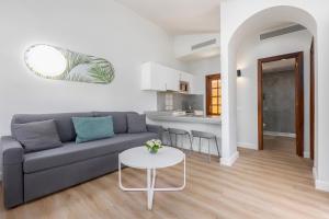 a living room with a couch and a table at Maspalomas Resort by Dunas in Maspalomas