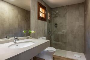 a bathroom with a toilet and a sink and a shower at Maspalomas Resort by Dunas in Maspalomas