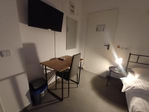 a small room with a table and a bed at G Residence in Ploieşti