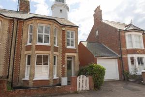a brick house with a lighthouse on top of it at Sole Rose in Southwold