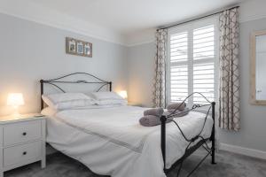 a bedroom with a bed with a teddy bear on it at Sole Rose in Southwold