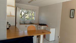 a kitchen with a wooden table and a window at 35 Pearce in Vosburg