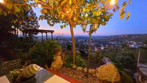 a street light sitting next to a tree with a view at Vida Daurada, sunny oasis with private pool in Vespellá