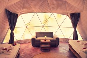 a room with a couch and a large window at Paradise city in Kidoti
