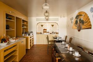 a restaurant with a long table in a room at Hôtel Folie - Orso Hotels in Paris