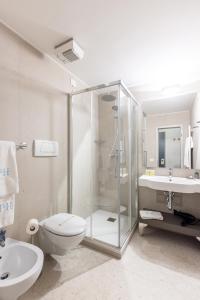 a bathroom with a shower and a toilet and a sink at Piazzi House in Sondrio +90 photos