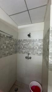 a bathroom with a shower with a sink at The Chill Spot in Greater Noida +27 photos