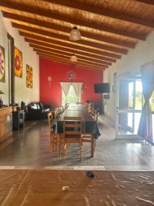 a dining room with a long table and chairs at El Colibrí Casa de Campo in Villa María