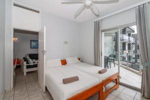 a bedroom with a bed with a ceiling fan at Seagull 407 in Margate
