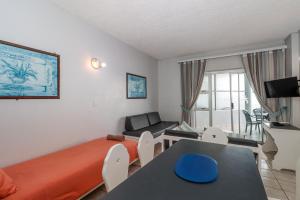 a bedroom with a bed and a table and a couch at Seagull 407 in Margate