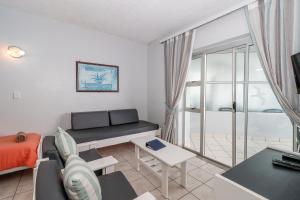 a living room with a couch and a table at Seagull 407 in Margate