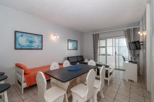 a living room with a table and a dining room at Seagull 407 in Margate