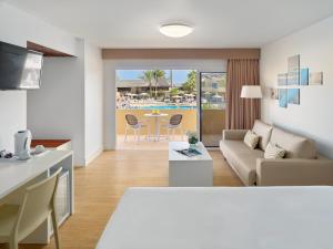 a living room with a couch and a table at Hotel Arena Suite - Adults Only in Corralejo